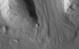 This image acquired on February 14, 2023 by NASA's Mars Reconnaissance Orbiter shows an example of material having flowed downhill between two ridges.