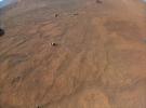 This image of NASA's Perseverance Mars rover was taken at an altitude of about 16 feet (5 meters) by the Ingenuity Mars Helicopter during its 54th flight on Aug. 3, 2023.