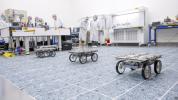 Part of NASA's CADRE technology demonstration, three small rovers show off their ability to drive as a team autonomously during a test in a clean room at the agency's Jet Propulsion Laboratory in December 2023.
