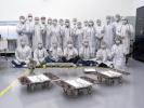 Members of the CADRE assembly, test, launch, and operations team pose with completed hardware in a clean room at JPL in late January, 2024.