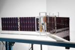One of the two shoebox-size CubeSats that make up NASA's PREFIRE mission sits on a table at Blue Canyon Technologies. The company built the satellite bus and integrated the JPL-provided thermal infrared spectrometer instrument.