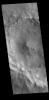 This image from NASA's Mars Odyssey shows dark streaks marking the inner rim of this unnamed crater in Terra Sabaea.