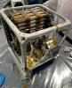 Seen here in November 2023, Farside Seismic Suite's inner cube houses the NASA payload's battery and two seismometers. The gold, puck-shaped device holds the Short Period sensor, while the silver enclosure contains the Very Broadband seismometer.