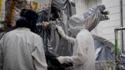 A planetary protection engineer carefully collects samples from NASA's Europa Clipper spacecraft to verify its biological cleanliness.